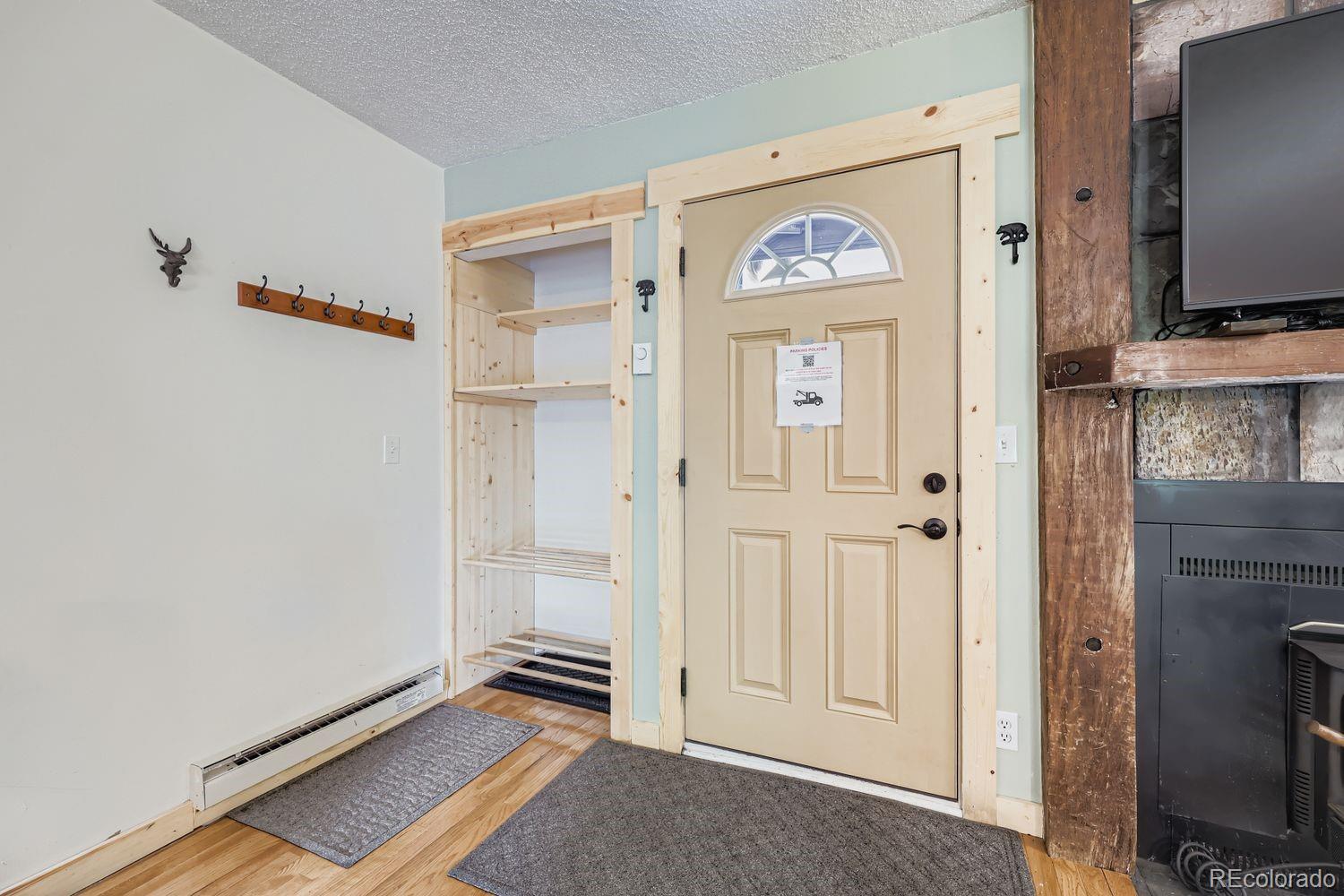 6916 Ryan Gulch Road, Unit 6916 Silverthorne, CO 80498 - Photo 4 of 33 a view of an entryway with wooden floor