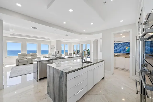 a kitchen with stainless steel appliances granite countertop a sink and stove