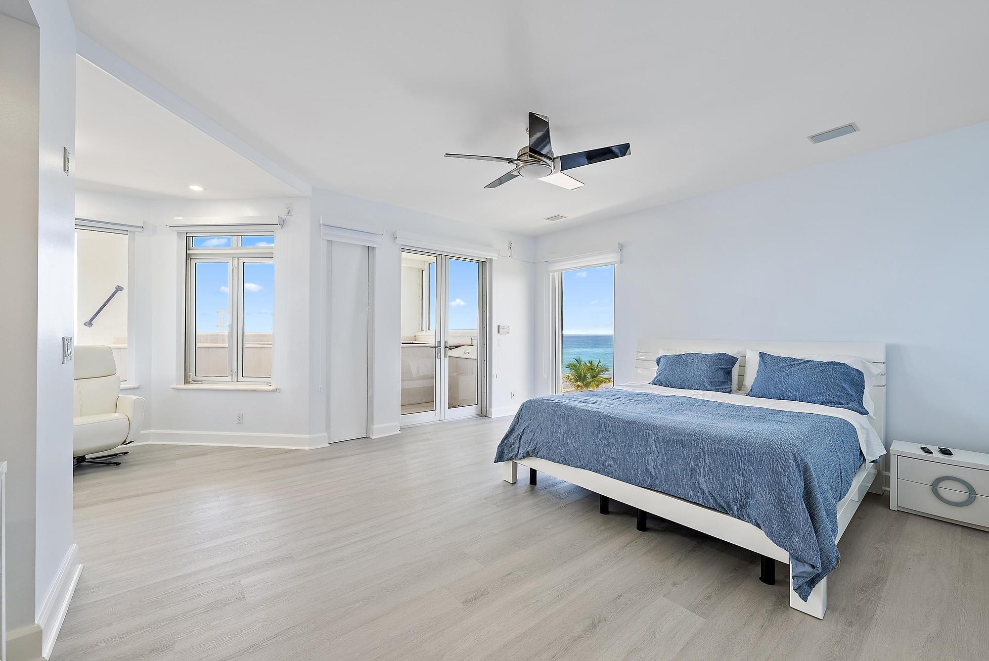 Undisclosed Address Boca Raton, FL 33431 - Photo 22 of 47 a bedroom with a bed and a chandelier