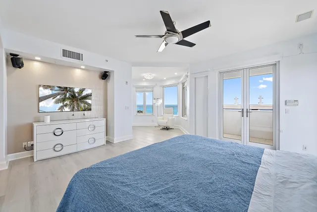 a bedroom with a bed and a painting on the wall