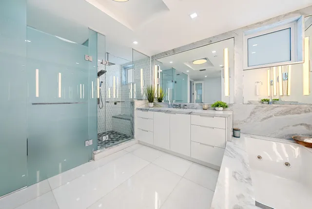 a bathroom with a double vanity sink mirror and shower