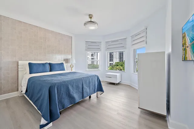 a spacious bedroom with a bed and a couch