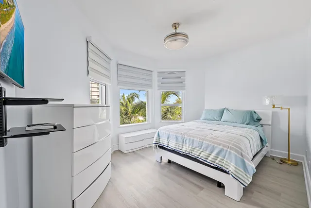 a bedroom with a bed windows and garden