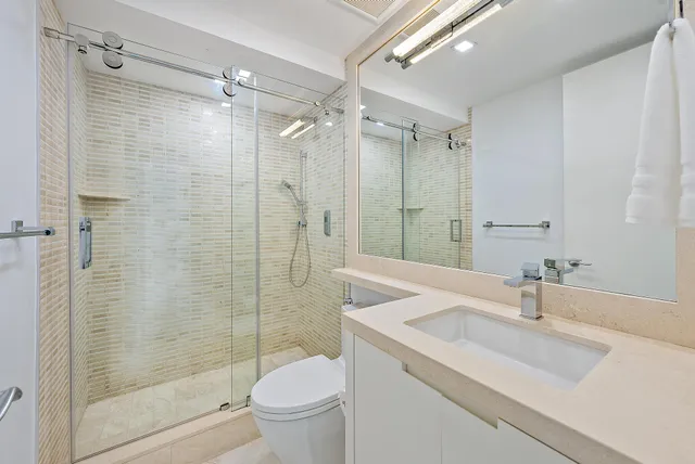 a bathroom with a sink toilet and shower