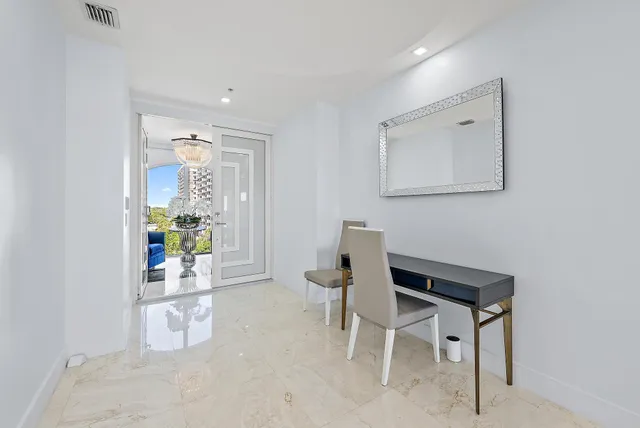 a dining room with furniture and a window