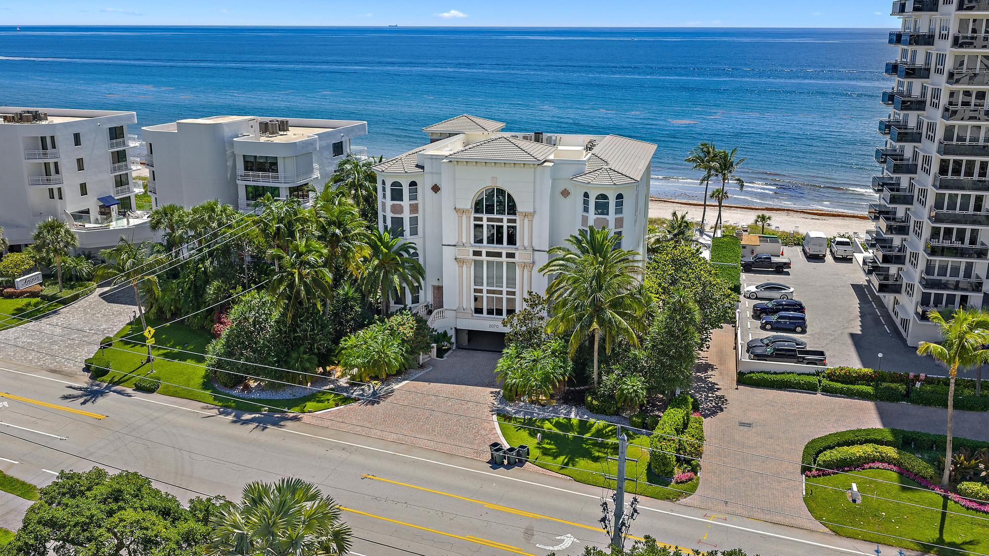 Undisclosed Address Boca Raton, FL 33431 - Photo 39 of 47 a view of a white house with a flower garden and potted plants