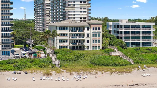 a front view of a residential apartment building with a yard