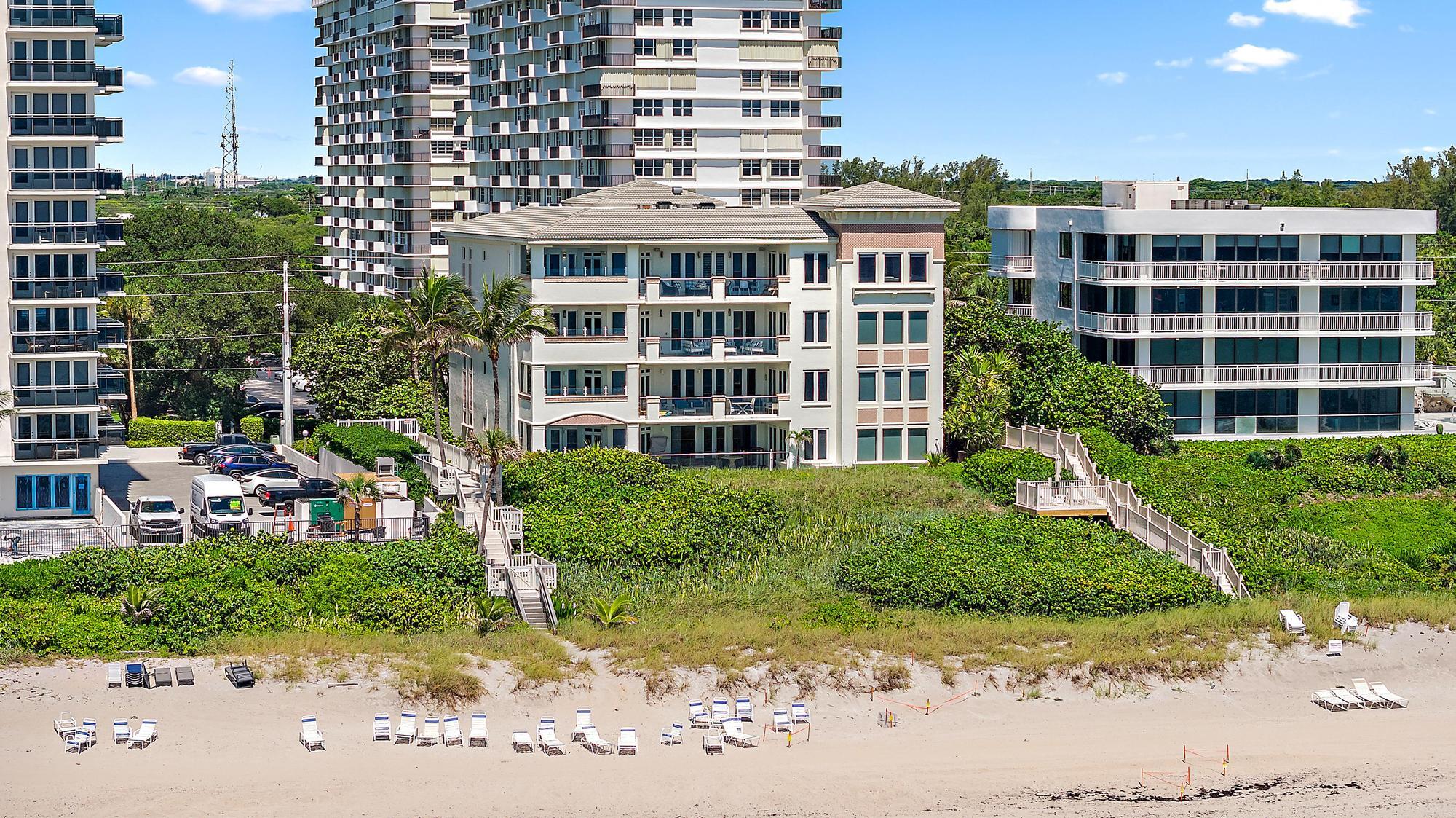 Undisclosed Address Boca Raton, FL 33431 - Photo 41 of 47 a front view of a residential apartment building with a yard