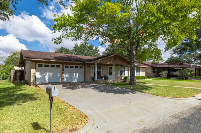 a front view of a house with garden