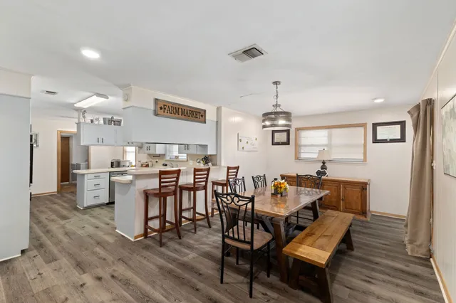 a dining room with furniture and wooden floor