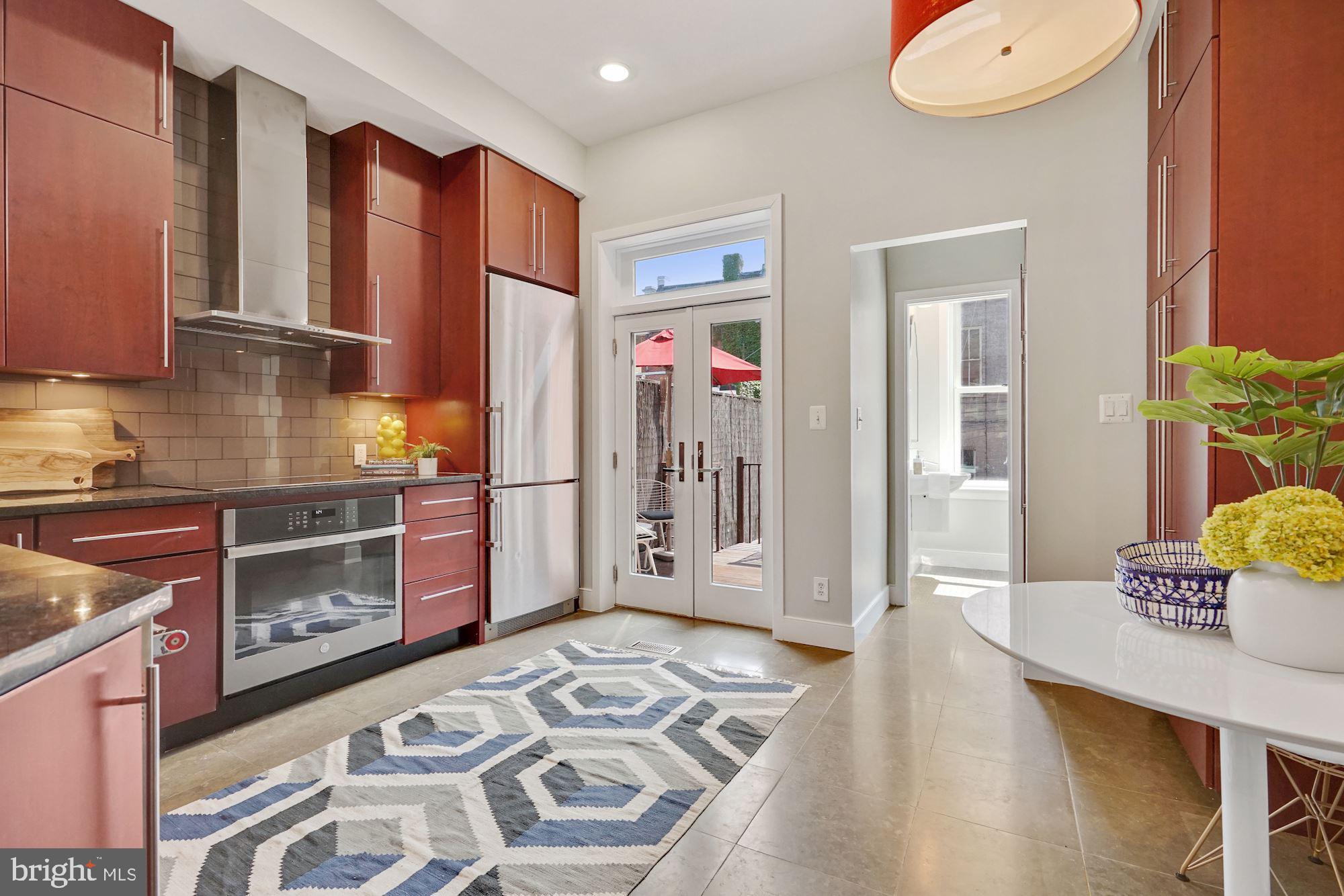 1830 Corcoran Street Northwest Washington, DC 20009 - Photo 5 of 20 Updated kitchen leads to porch