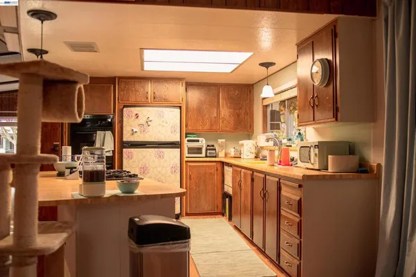 a kitchen with stainless steel appliances granite countertop a sink stove and cabinets