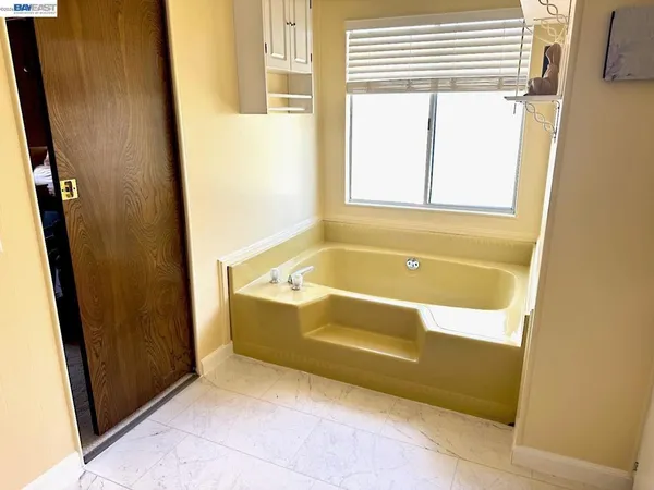 a bath tub sitting next to a window