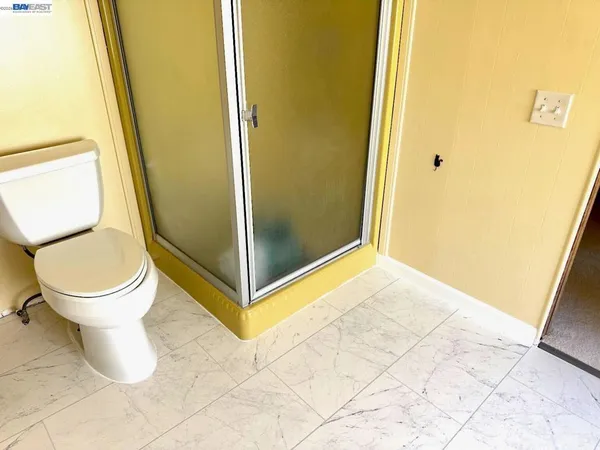 a bathroom with a toilet and a shower