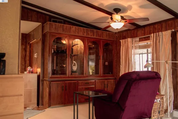 a view of a hallway with furniture and chandelier