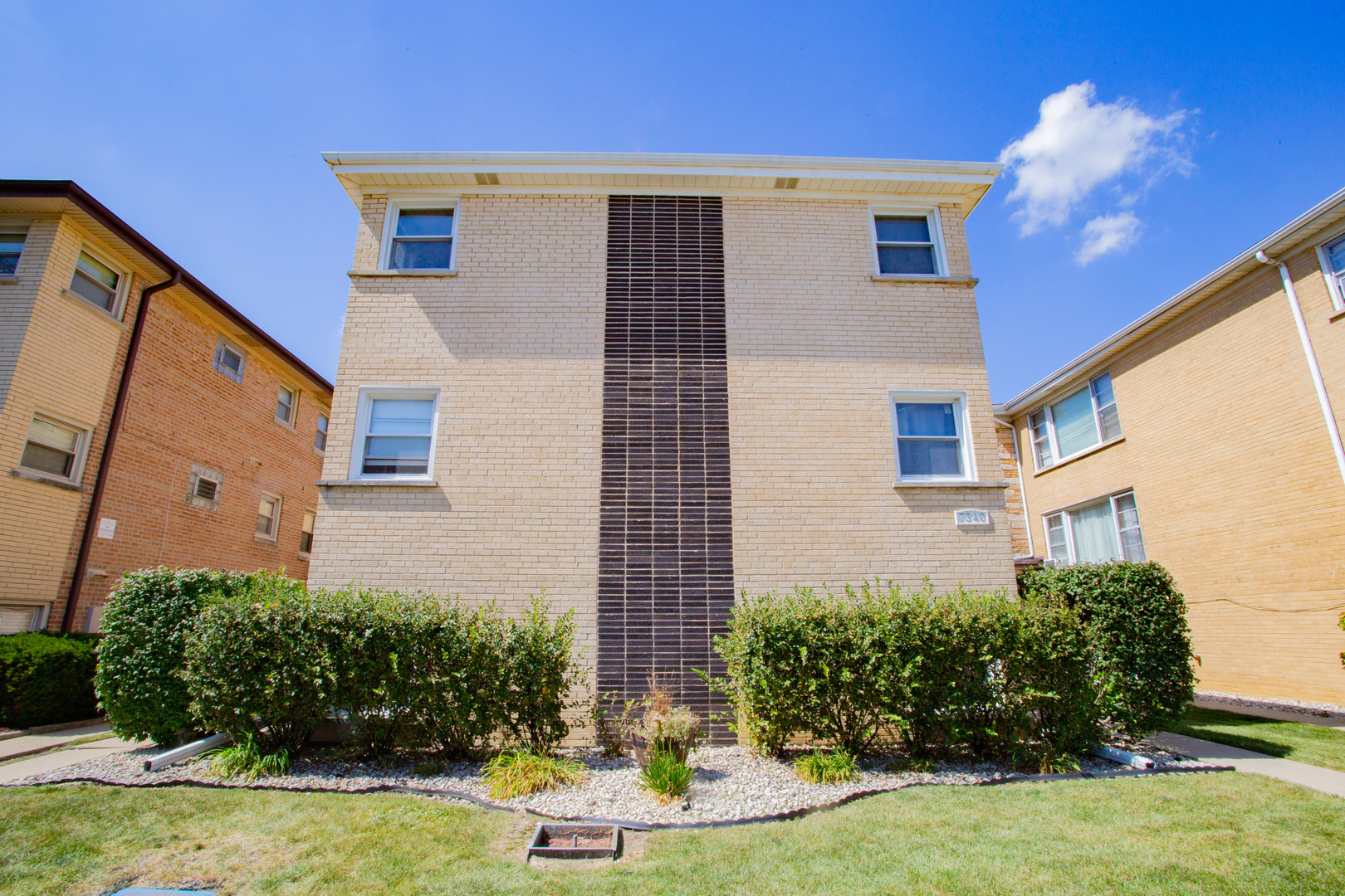 7340 North Harlem Avenue, Unit 1W Chicago, IL 60631 - Photo 1 of 14 a front view of a house with garden
