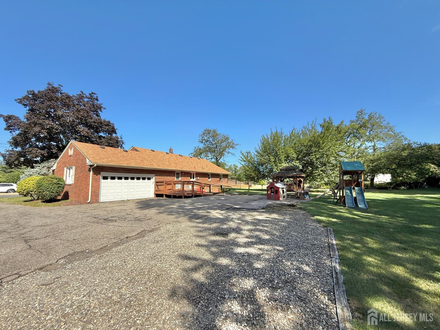 452 Cranbury Road East Brunswick, NJ 08816 - Photo 15 of 16 a view of a house with a yard and garage