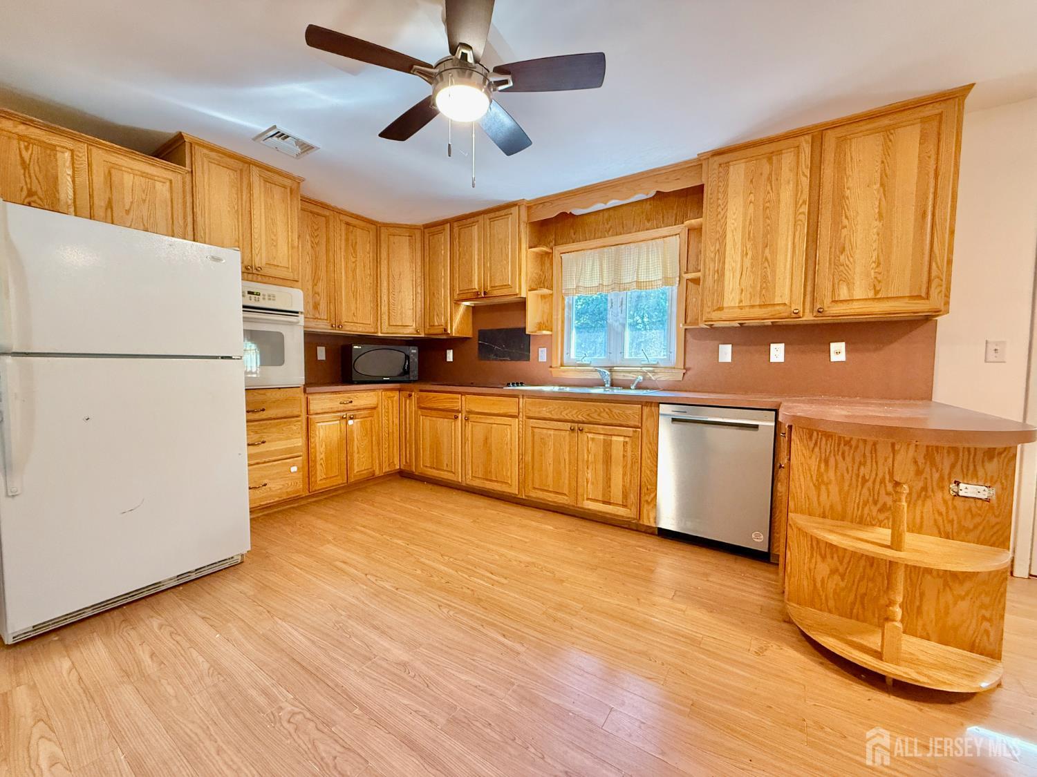 452 Cranbury Road East Brunswick, NJ 08816 - Photo 5 of 16 a kitchen with stainless steel appliances granite countertop a refrigerator a sink dishwasher and a stove with wooden floor