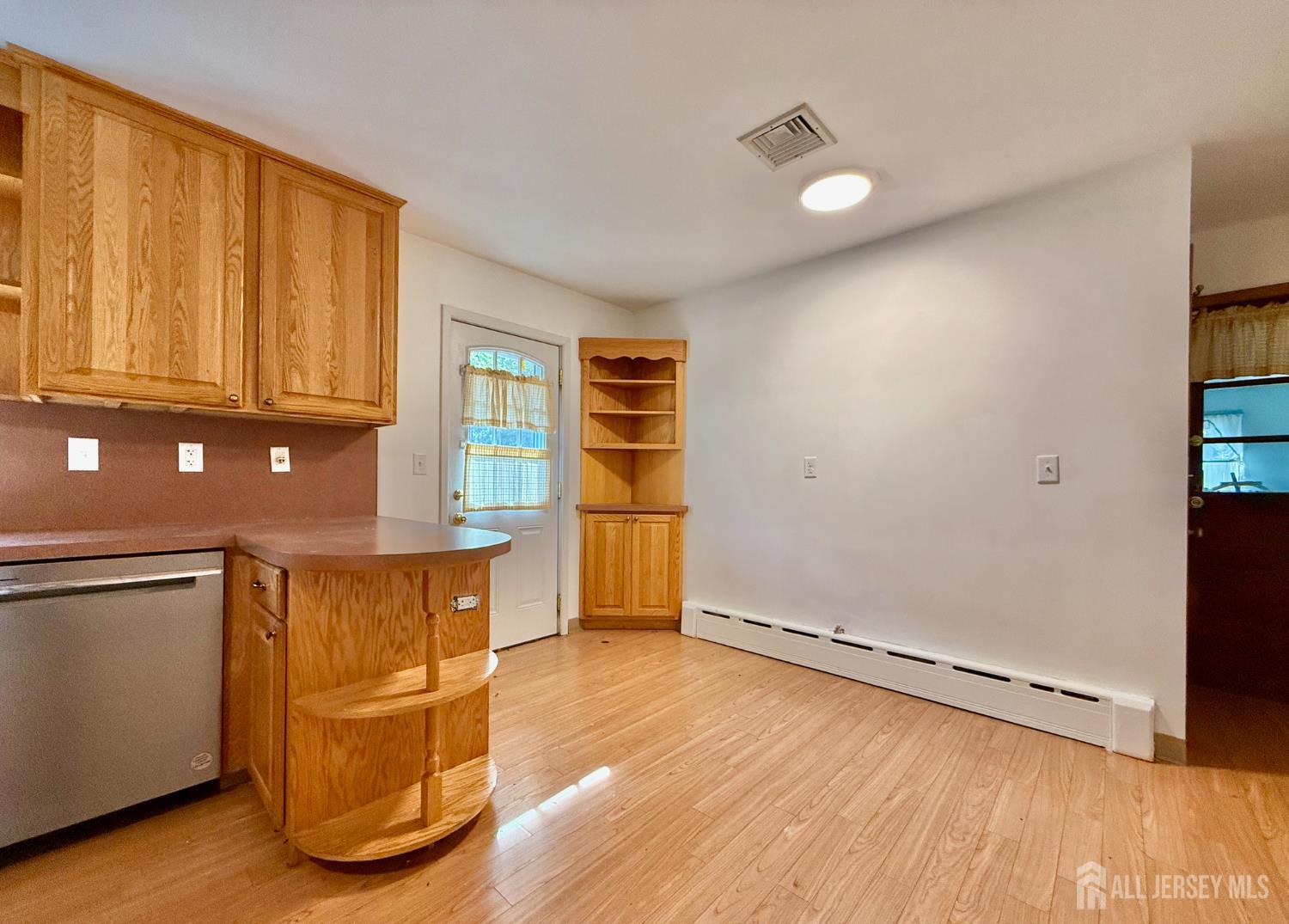 452 Cranbury Road East Brunswick, NJ 08816 - Photo 6 of 16 an empty room with wooden floor and windows