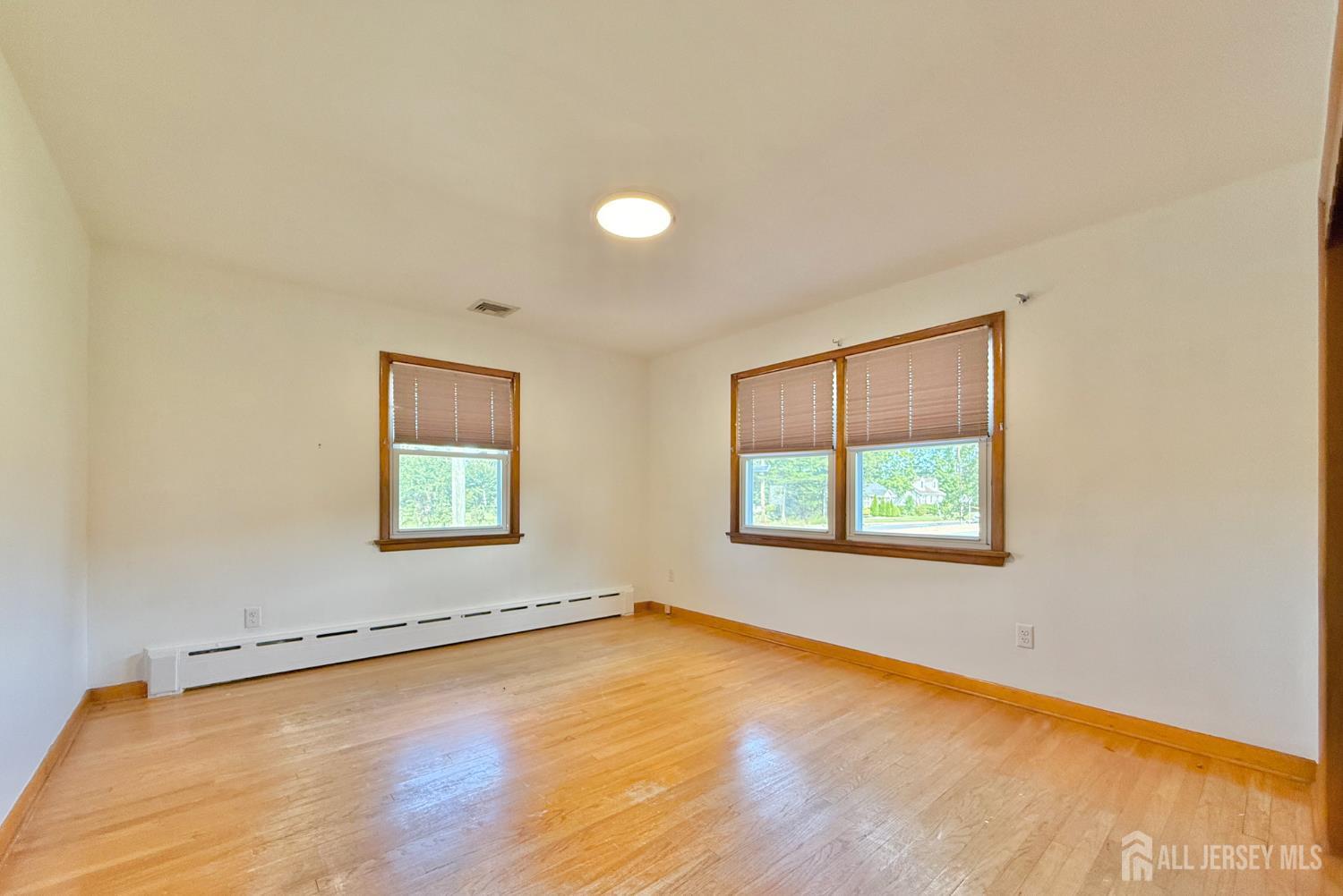 452 Cranbury Road East Brunswick, NJ 08816 - Photo 8 of 16 an empty room with a window