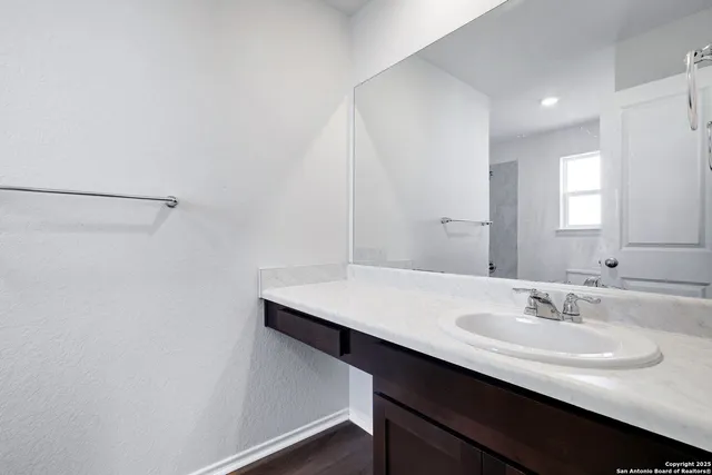 a bathroom with a sink a mirror and a vanity