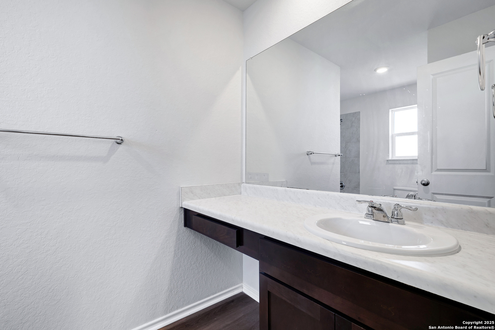 5867 Kendall Prairie San Antonio, TX 78244 - Photo 16 of 25 a bathroom with a sink a mirror and a vanity