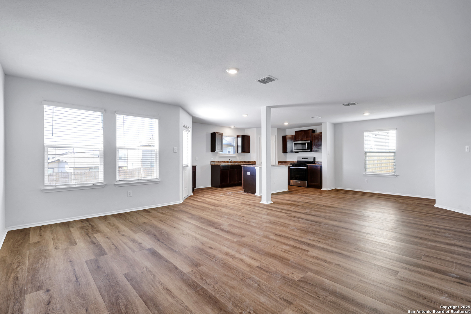 5867 Kendall Prairie San Antonio, TX 78244 - Photo 3 of 25 an empty room with kitchen fireplace and windows