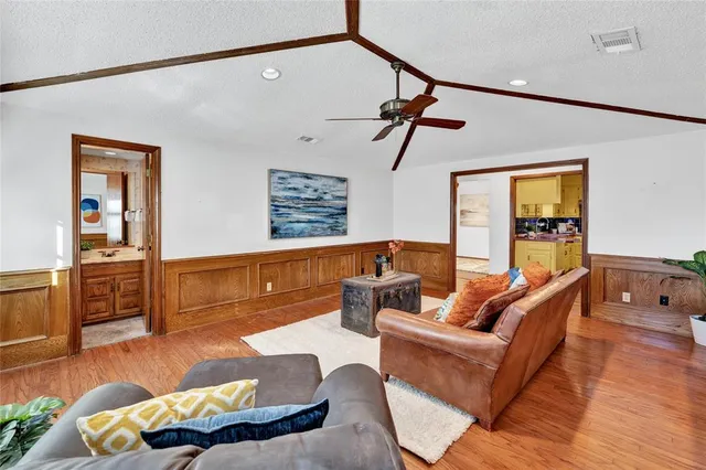 a view of a bedroom with wooden floor and a potted plant