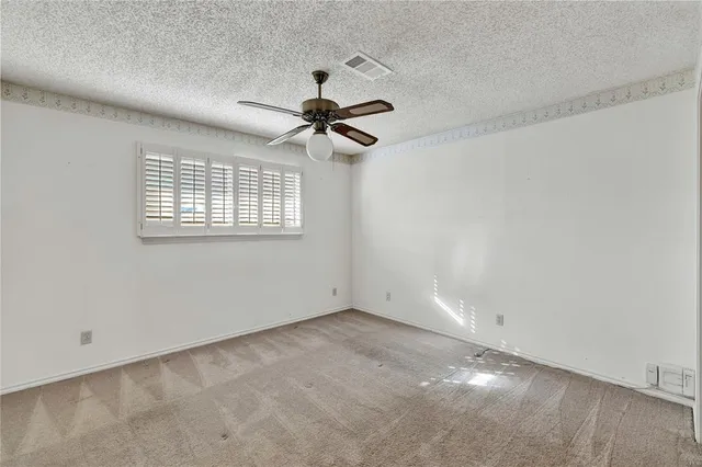 a view of a livingroom with a ceiling fan and entryway
