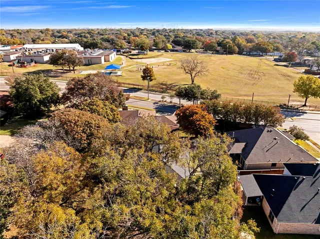 a aerial view of a house with large trees