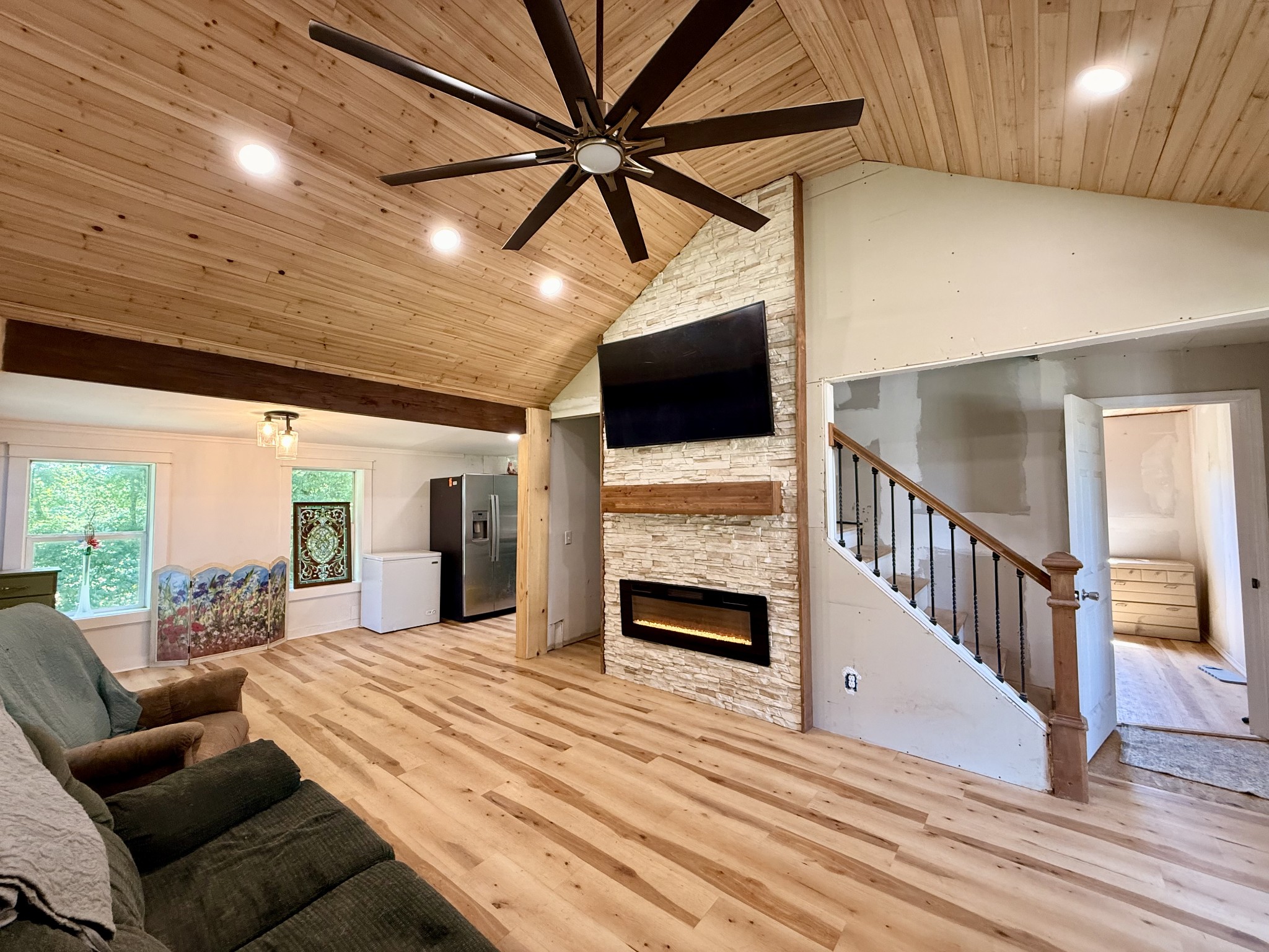 374 State Line Road Loretto, TN 38469 - Photo 1 of 24 a view of a livingroom with furniture a flat screen tv wooden floor and a ceiling fan