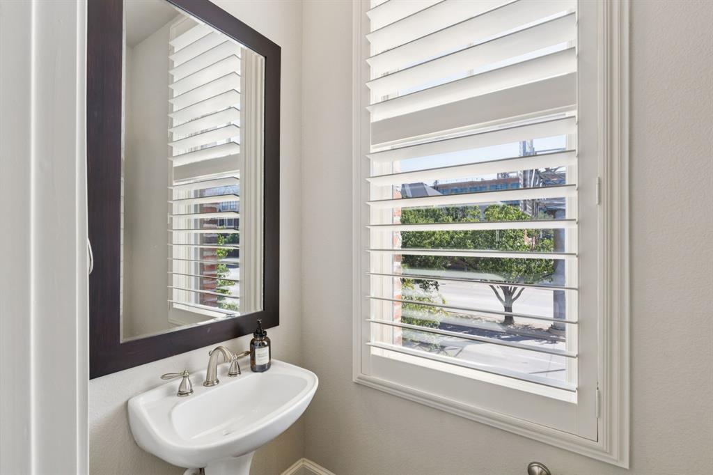 561 South Cesar Chavez Boulevard Dallas, TX 75201 - Photo 16 of 40 a bathroom with a sink a mirror and a window