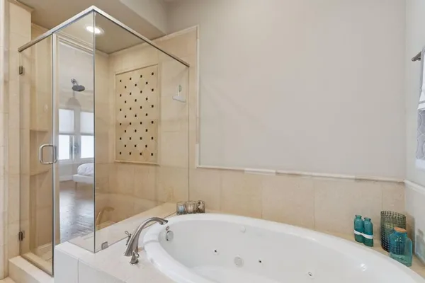 a bathroom with bathtub and shower