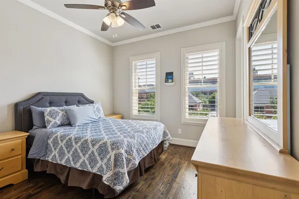 a bedroom with a large bed and a window