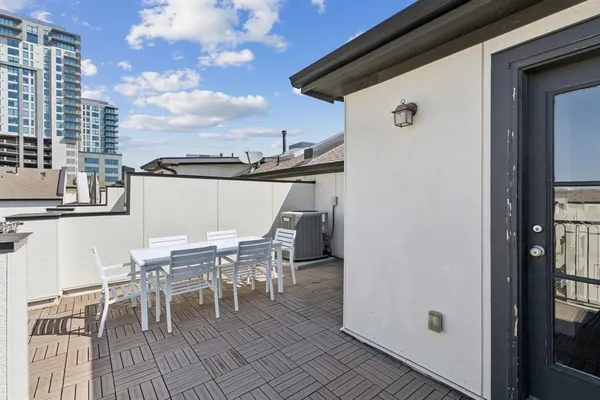 a view of a patio with table and chairs