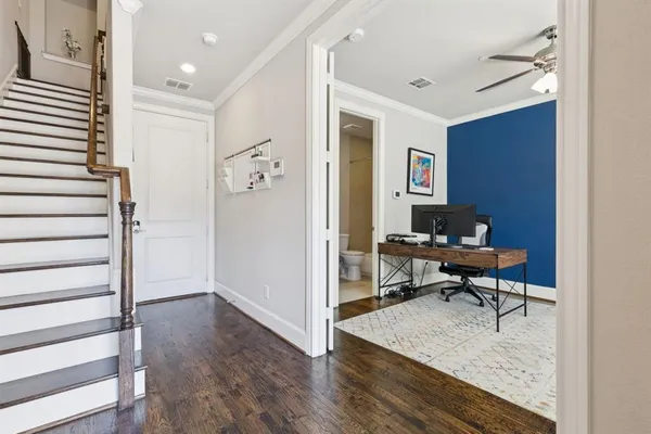a view of a workspace with furniture and a window