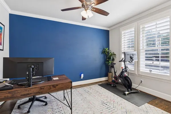 a view of a workspace with furniture and a window
