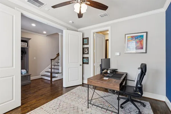 a view of a workspace with furniture and wooden floor