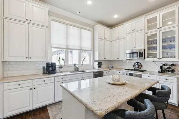 a kitchen with cabinets appliances and a counter top space