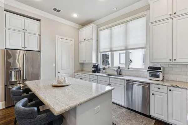 a kitchen with a sink stove and cabinets