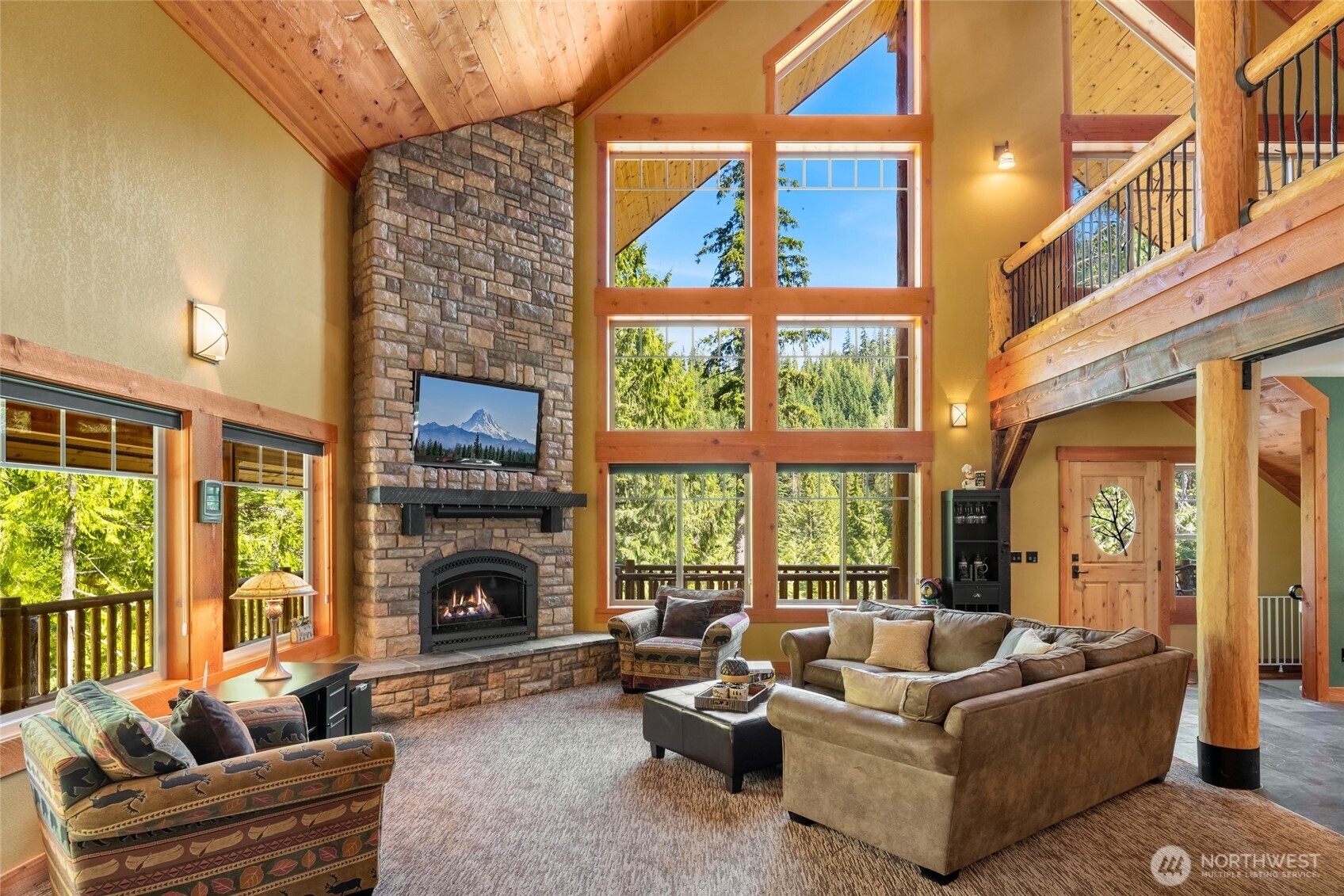 4422 Kachess Lake Road Easton, WA 98925 - Photo 13 of 36 a living room with furniture a fireplace and a floor to ceiling window