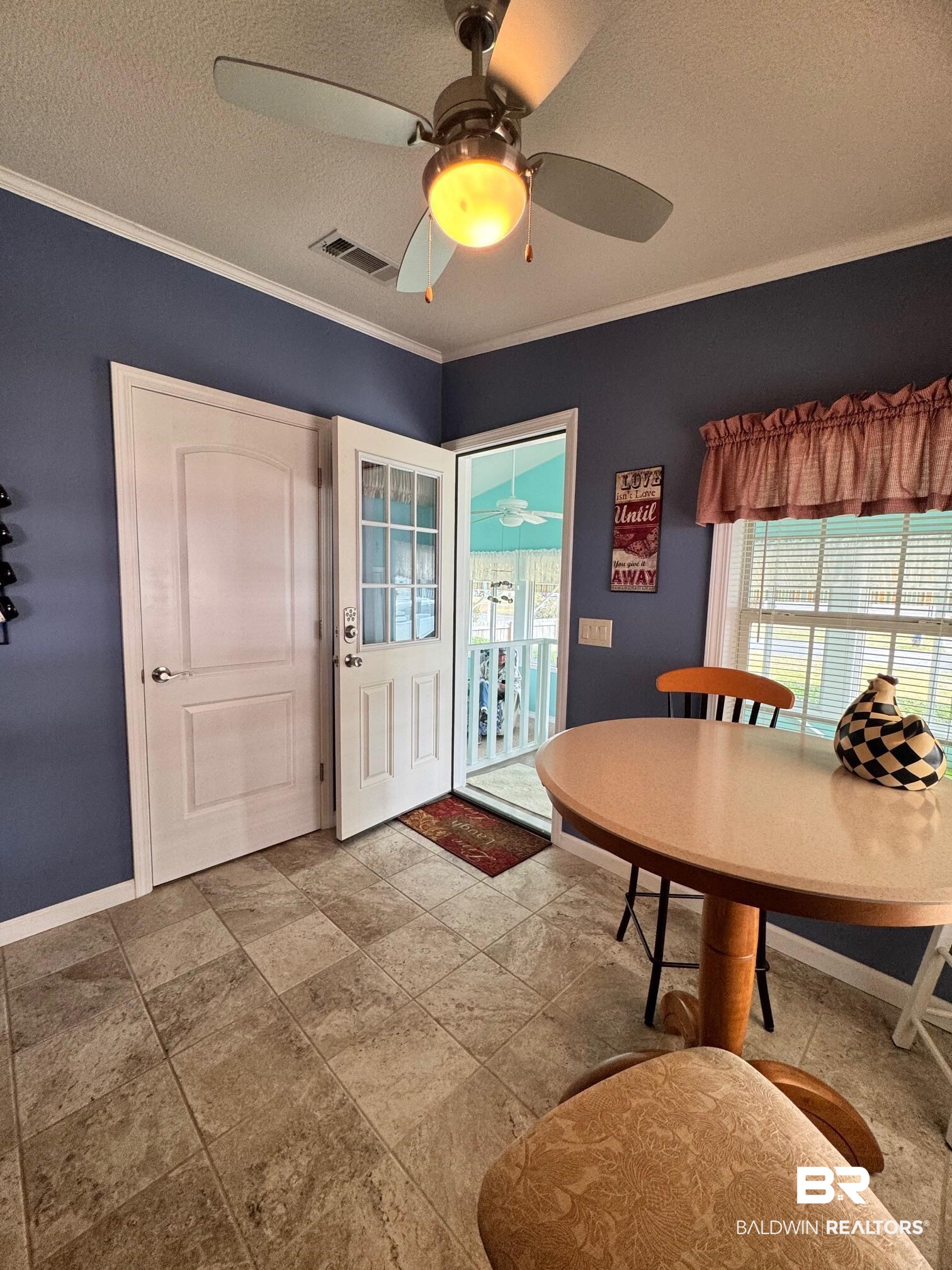 1165 Santa Anna Lane Lillian, AL 36549 - Photo 5 of 43 Dining area with a textured ceiling, baseboards, visible vents, and crown molding