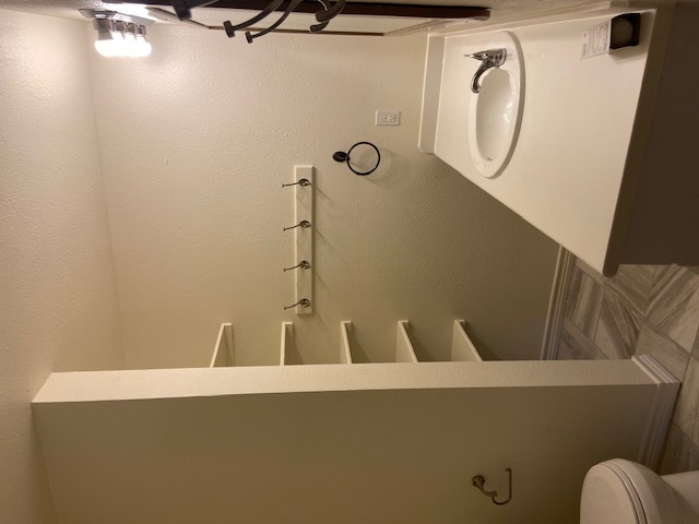 823 Monterrey Street Lockhart, TX 78644 - Photo 7 of 14 a bathroom with a toilet and a sink
