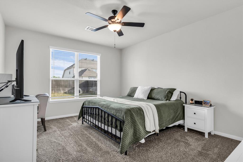 7008 Llano Drive China Spring, TX 76633 - Photo 12 of 26 a bedroom with a bed and a chandelier