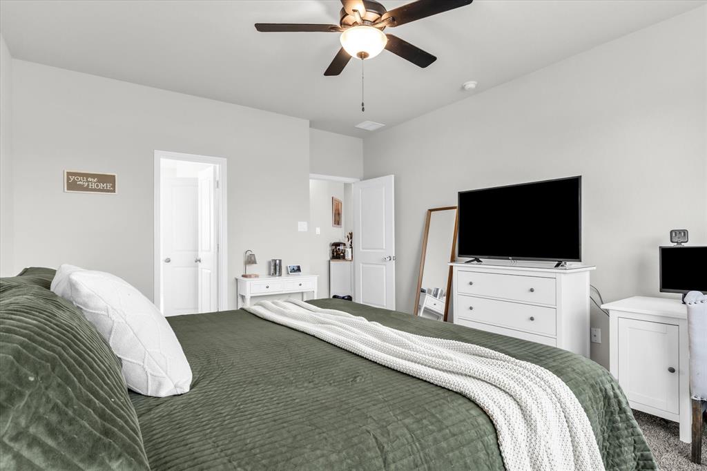7008 Llano Drive China Spring, TX 76633 - Photo 13 of 26 a bedroom with a bed and a flat screen tv