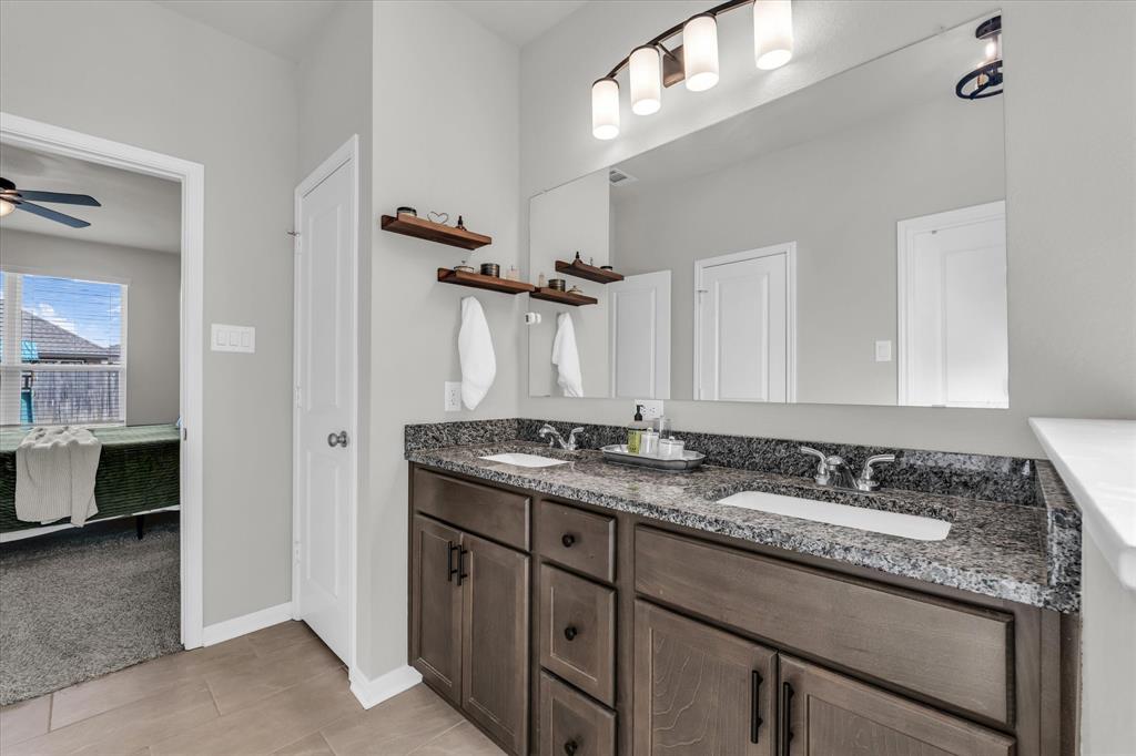 7008 Llano Drive China Spring, TX 76633 - Photo 14 of 26 a bathroom with a granite countertop sink and a mirror