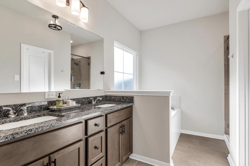 7008 Llano Drive China Spring, TX 76633 - Photo 15 of 26 a bathroom with a granite countertop sink and a mirror