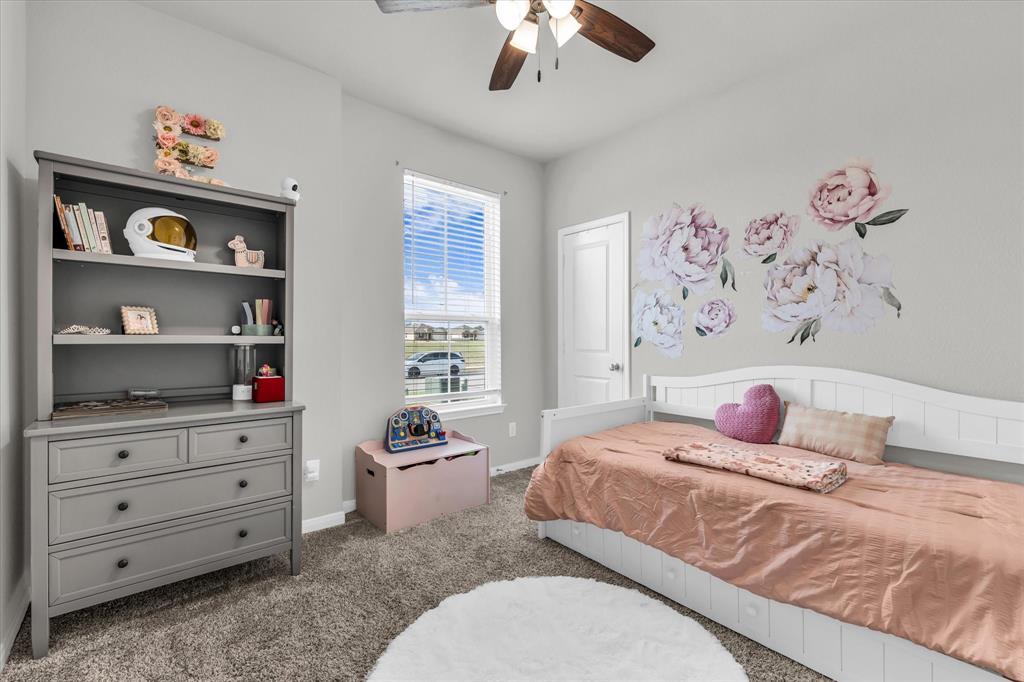 7008 Llano Drive China Spring, TX 76633 - Photo 17 of 26 a bedroom with a bed and a book shelf