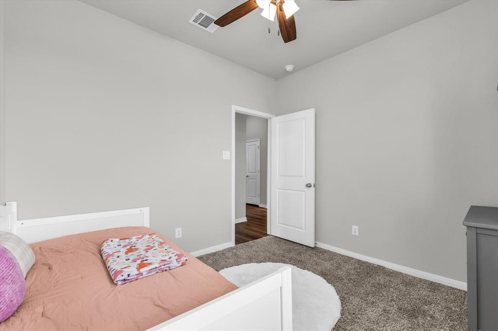 7008 Llano Drive China Spring, TX 76633 - Photo 18 of 26 a bedroom with a bed and a chandelier