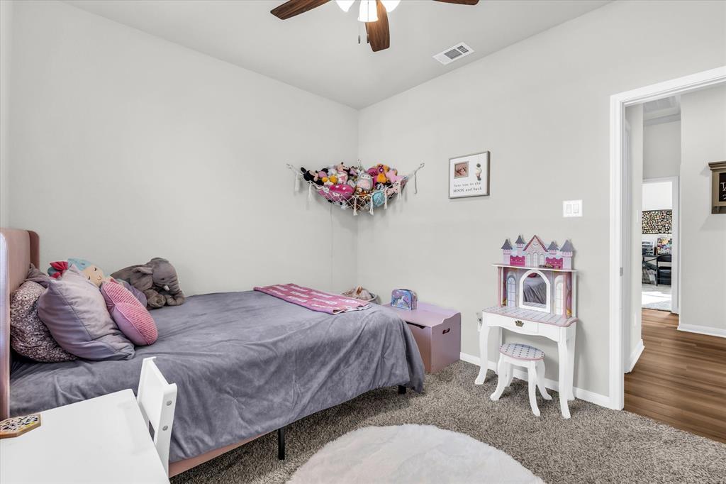 7008 Llano Drive China Spring, TX 76633 - Photo 20 of 26 a bedroom with a bed and a chandelier